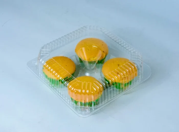 "Transparent quad muffin packaging filled with vibrant yellow muffins on www.jcpackaging.net, highlighting product freshness and quality."