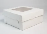 "Sturdy white paper cake box with transparent window, perfect for showcasing confectionery delights - find it at www.jcpackaging.net"