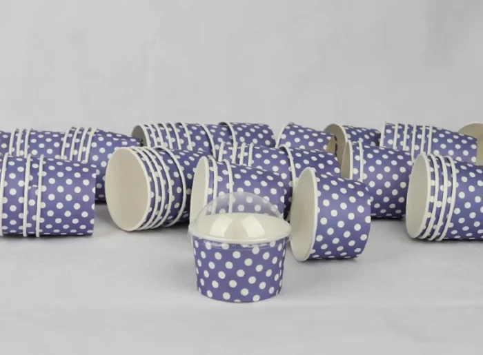 "A collection of medium-sized blue ice cream cups with white polka dots, perfect for serving sweet treats from www.jcpackaging.net."