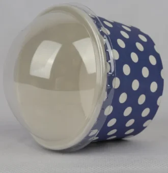 "A medium-sized ice cream cup adorned with white polka dots on a navy blue background, featuring a transparent dome lid, from www.jcpackaging.net."