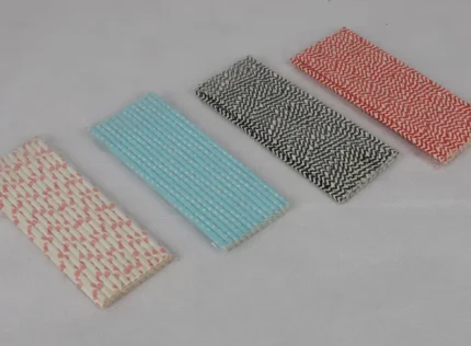 "An assortment of eco-friendly paper straws in various patterns and colors, available at www.jcpackaging.net."