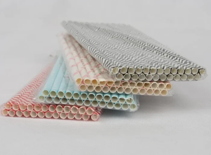 "An assortment of eco-friendly paper straws in various patterns and colors, available at www.jcpackaging.net."