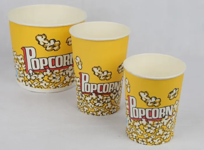 "Three yellow popcorn buckets with 'Popcorn' text and popping kernels design by www.jcpackaging.net, showcasing different sizes."