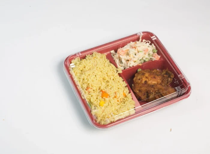 "Appetizing prepped meal in a clamshell meal tray with rice, vegetables, and grilled chicken, highlighting JC Packaging's quality design."